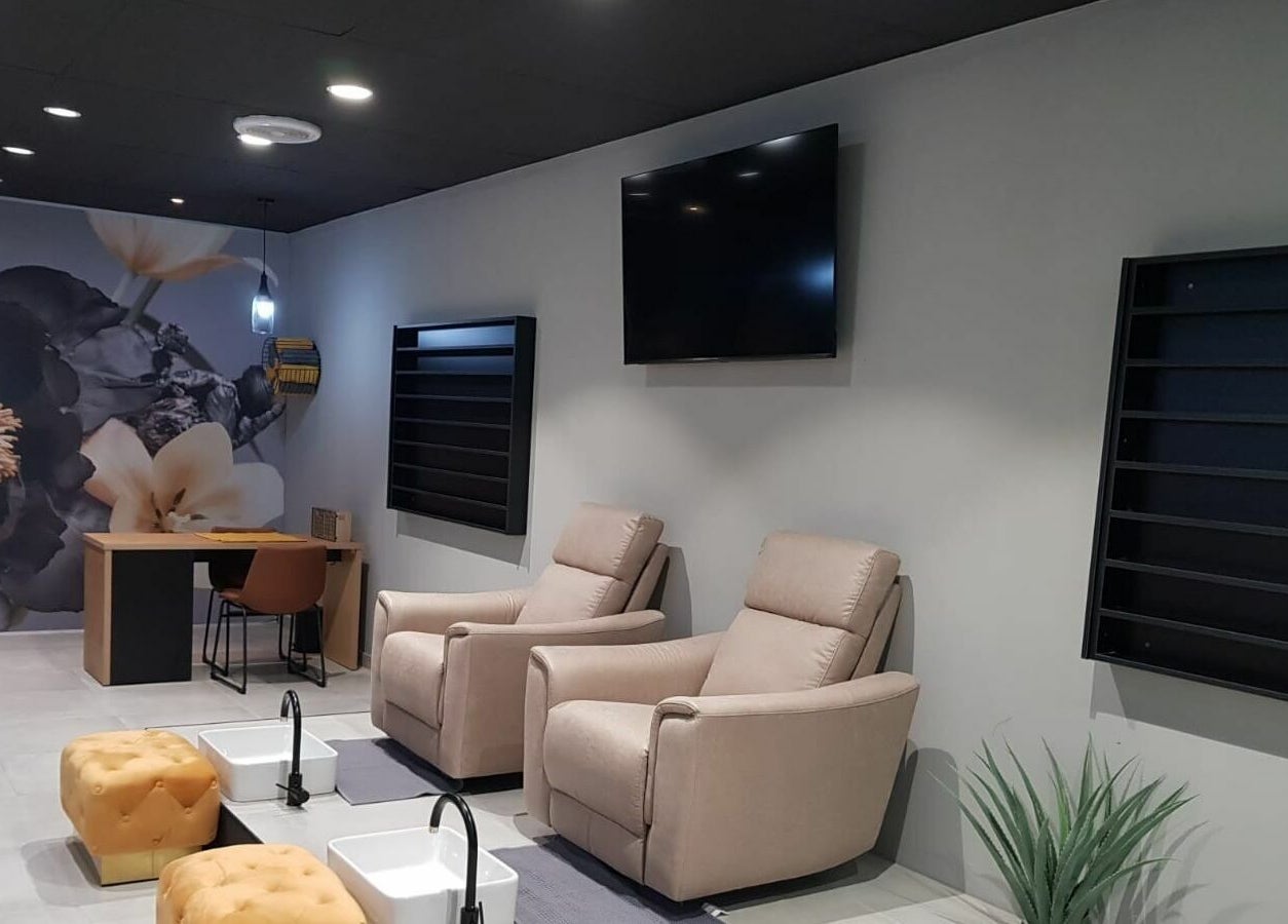 Chic interior of Giggles n Kurls Nail Studio Bryanston, Sandton, Gauteng, ZA with plush seating and floral decor.