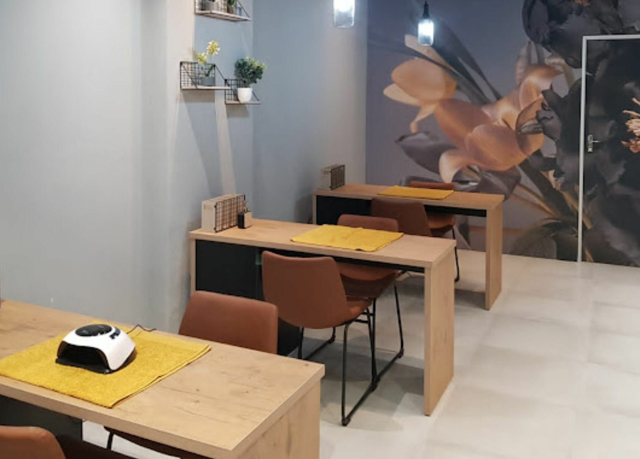 Chic manicure stations at Giggles n Kurls Nail Studio Bryanston in Sandton, Gauteng, ZA with floral decor.