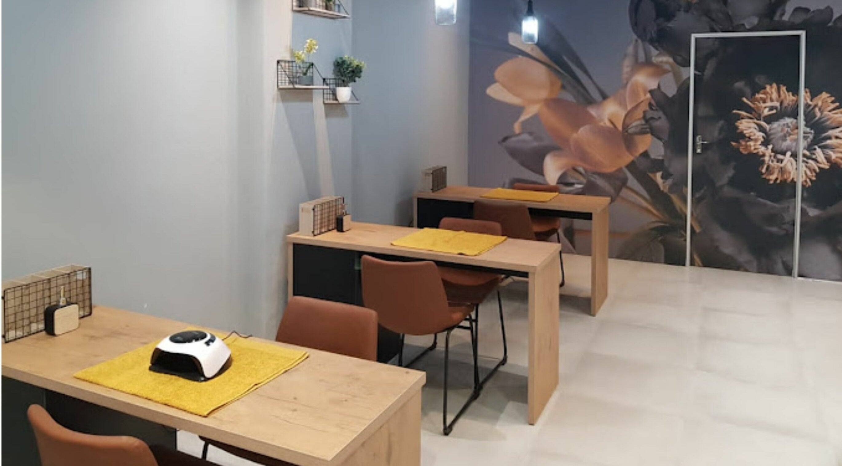 Chic manicure stations at Giggles n Kurls Nail Studio Bryanston in Sandton, Gauteng, ZA with floral decor.