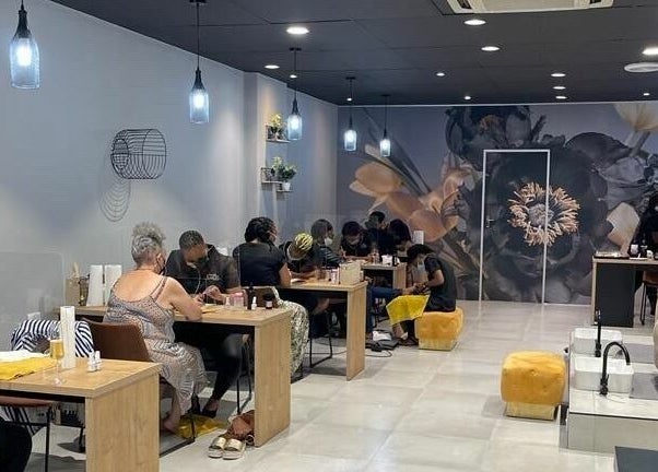 Visitors enjoying manicures at Giggles n Kurls Nail Studio Bryanston, Sandton, Gauteng, ZA in a cozy setting.