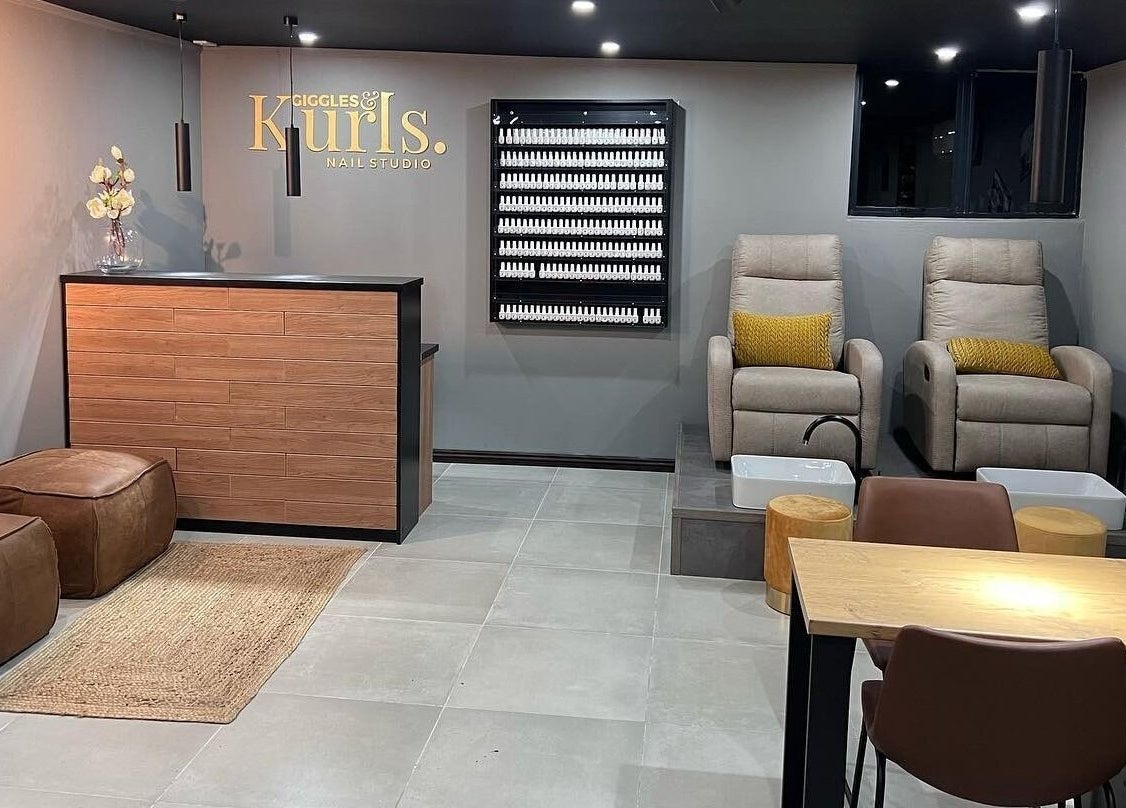Interior of Giggles n Kurls Nail Studio Hartbeespoort, featuring cozy chairs and elegant decor in Hartbeespoort, North West, ZA.