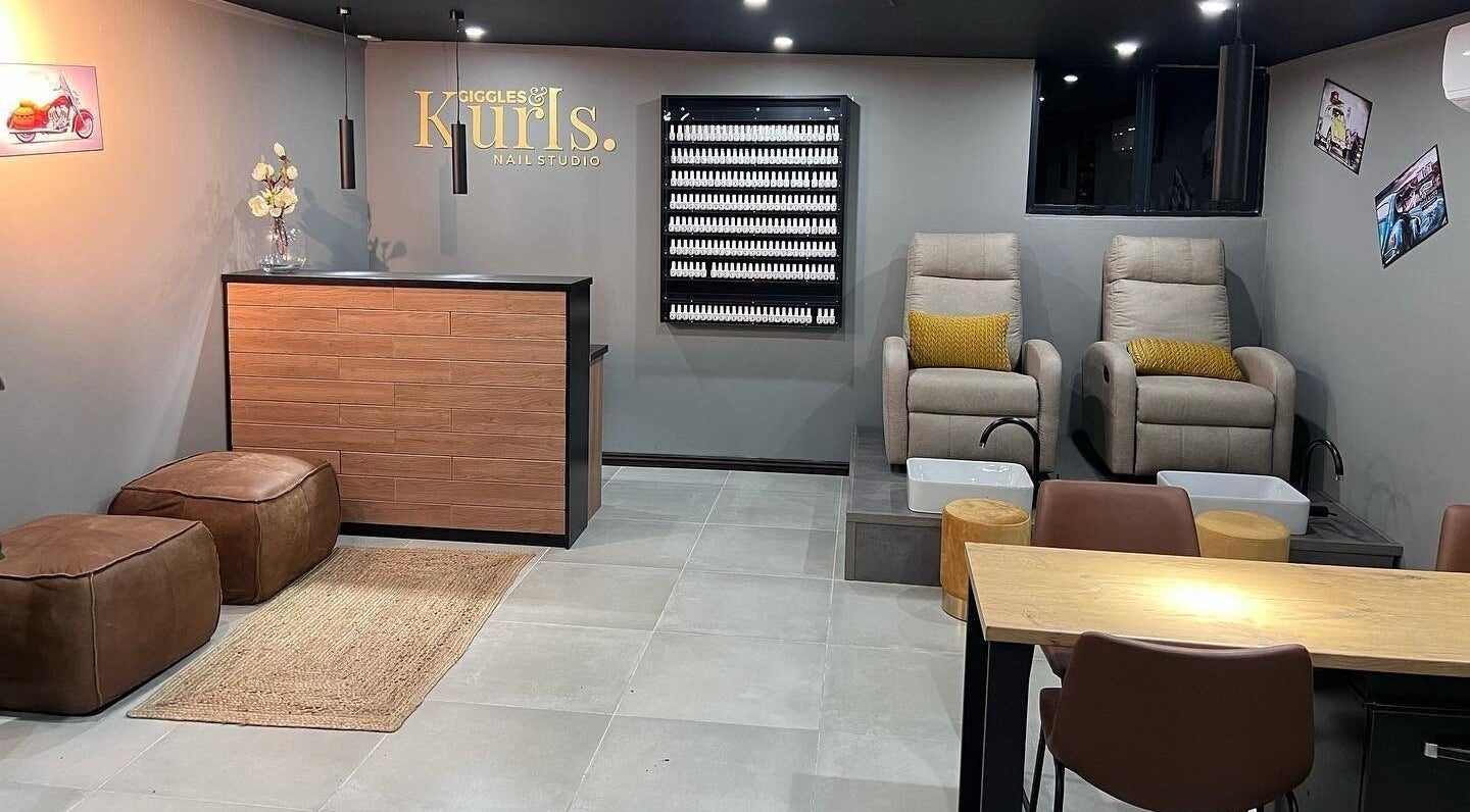 Interior of Giggles n Kurls Nail Studio Hartbeespoort, featuring cozy chairs and elegant decor in Hartbeespoort, North West, ZA.