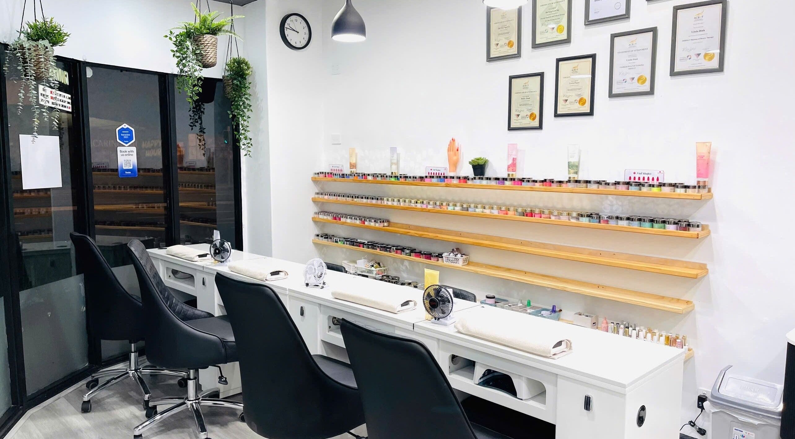 Inside Dazzling Nails and Beauty, Caringbah, New South Wales, AU. Sleek nail station with shelves lined with nail polish.