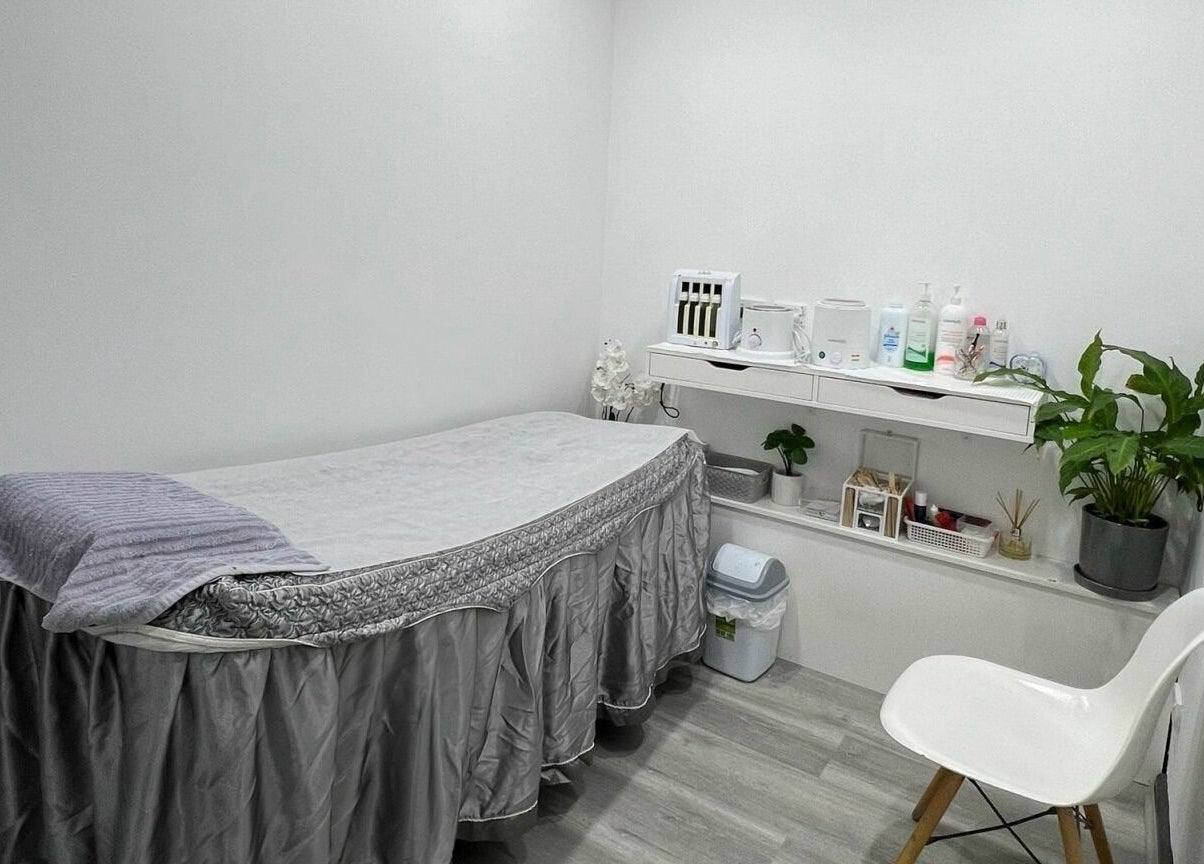 Relaxing treatment room at Dazzling Nails and Beauty, Caringbah, New South Wales, AU featuring a cozy bed and plants.