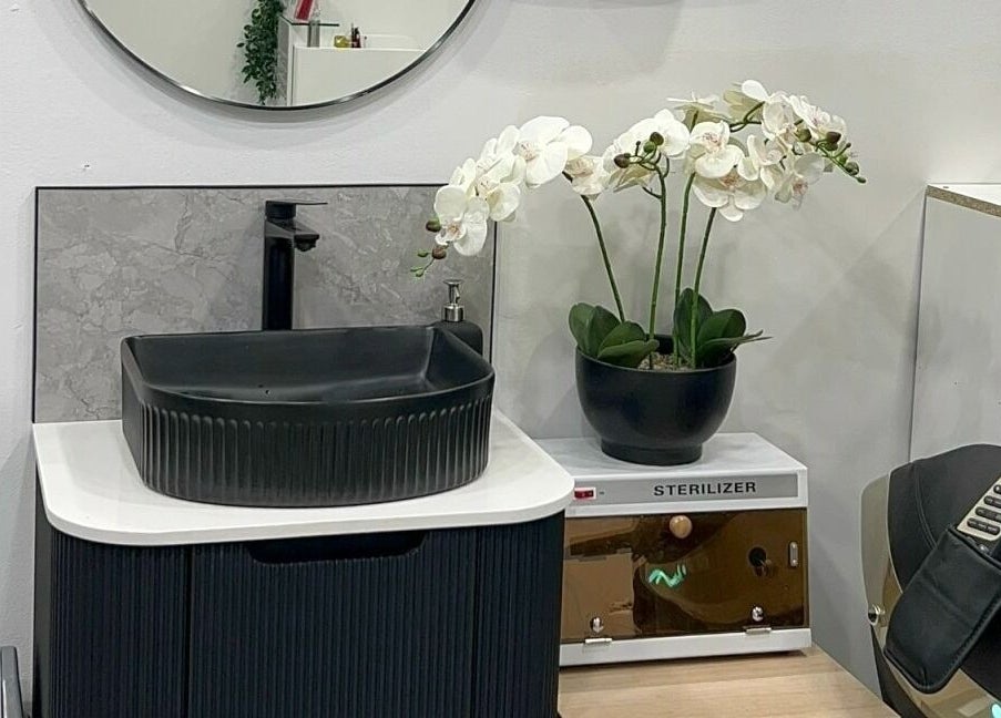 Stylish black sink with orchid at Dazzling Nails and Beauty, Caringbah, New South Wales, AU.