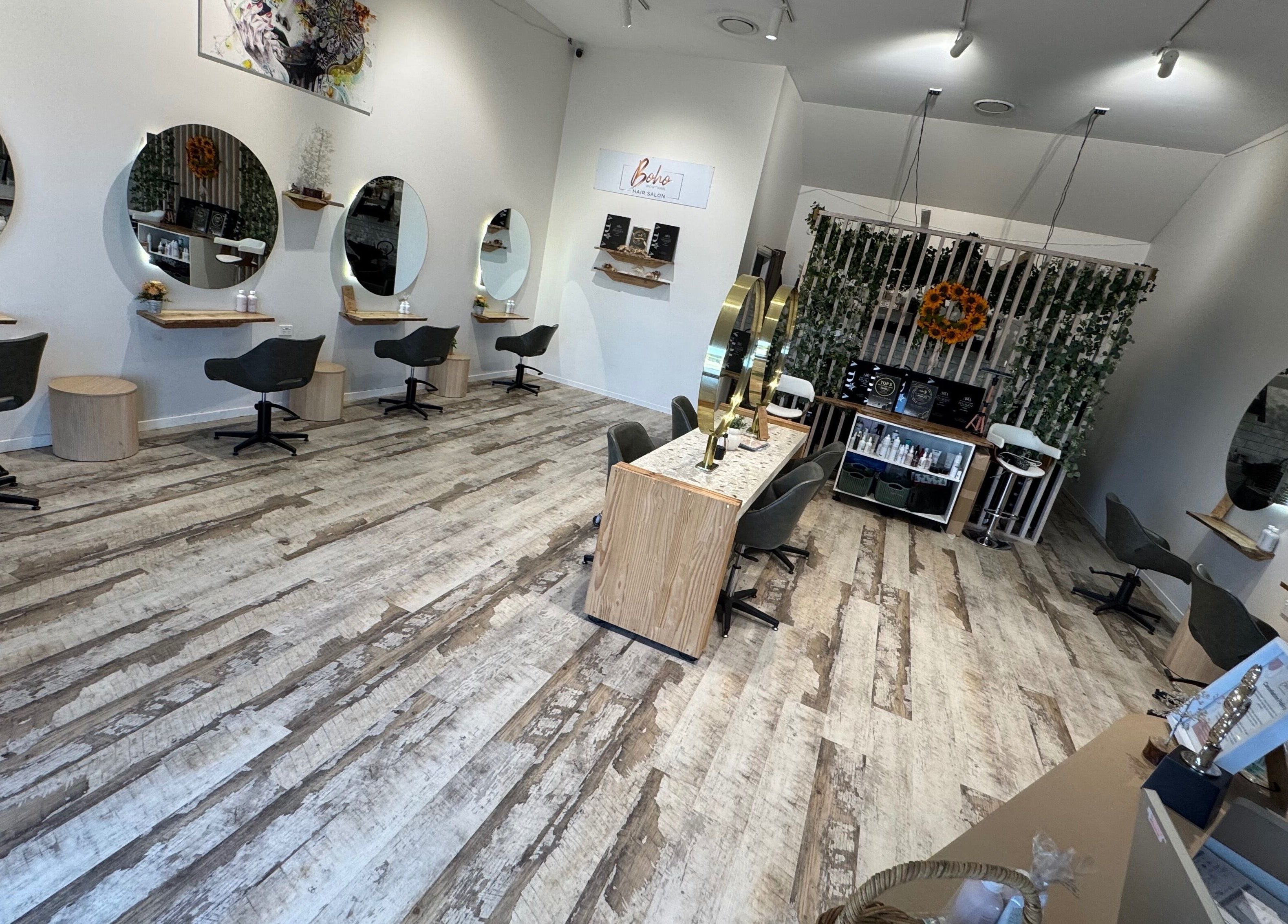 Stylish interior of Boho Boutique Hair Salon, Yarrabilba, Queensland, AU with chic mirrors and seating.