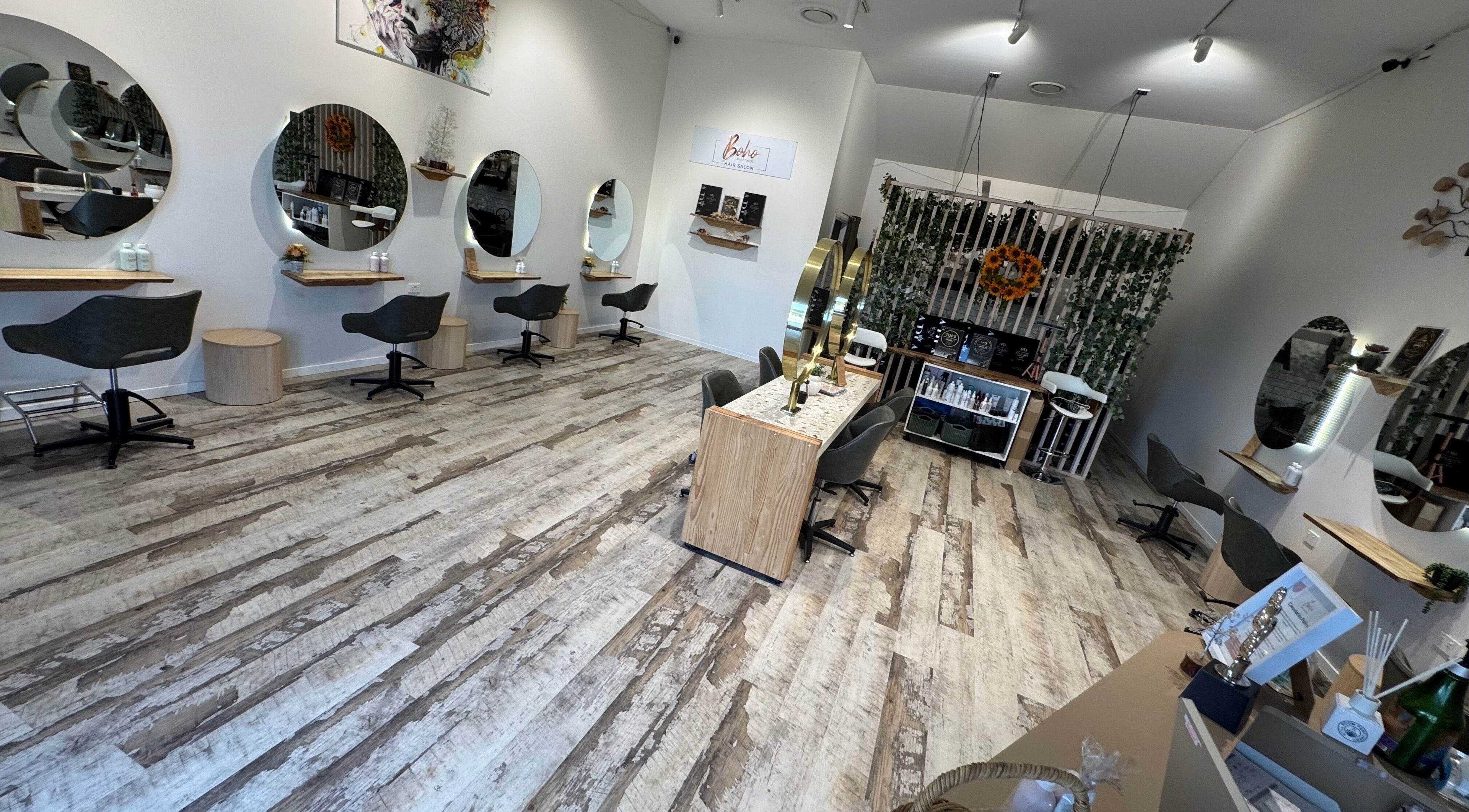 Stylish interior of Boho Boutique Hair Salon, Yarrabilba, Queensland, AU with chic mirrors and seating.