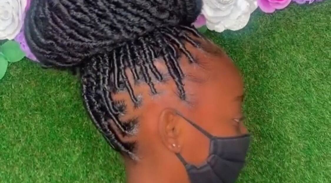 Intricate braided hairstyle at Royaltii Designs, Bridgetown, Saint Michael, BB, against a floral backdrop.