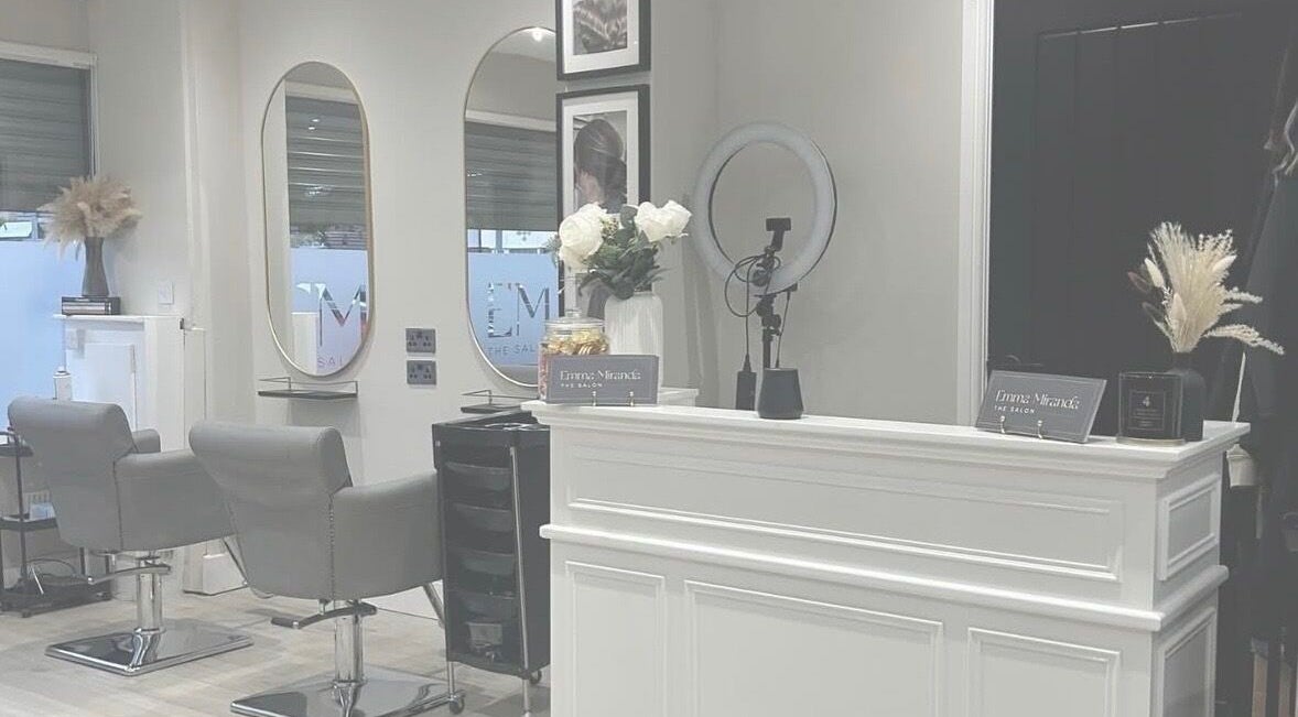 Interior of Natalie Louise Hairdressing in Whiston, England, GB featuring modern styling chairs and elegant decor.