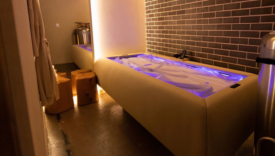 Luxurious spa room at Body WRL, Rosebery, NSW, AU with ambient lighting and plush massage bed.