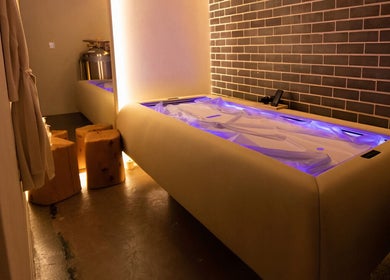 Luxurious spa room at Body WRL, Rosebery, NSW, AU with ambient lighting and plush massage bed.