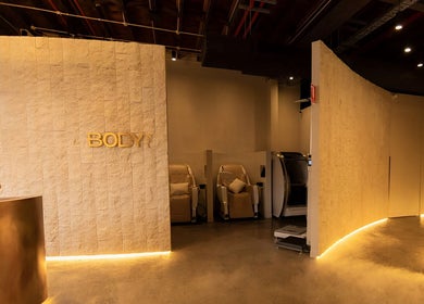 Luxurious golden interiors of Body WRL in Rosebery, NSW, AU, showcasing a tranquil wellness ambiance.