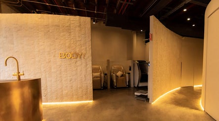 Luxurious golden interiors of Body WRL in Rosebery, NSW, AU, showcasing a tranquil wellness ambiance.