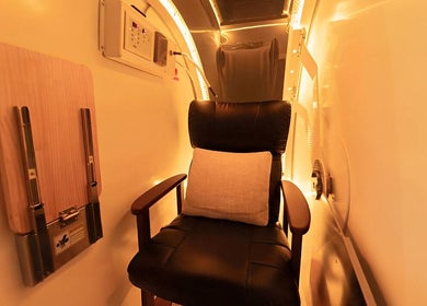 Relaxing wellness chamber at Body WRL, Rosebery, NSW, AU, showcasing a comfortable chair and soothing lighting.