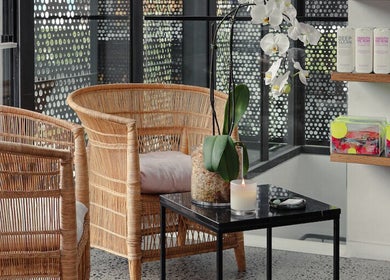 Relaxing seating area at Willomina, Woollahra, New South Wales, AU with wicker chairs and orchid decor.