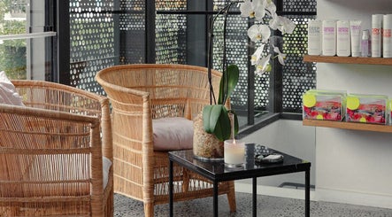 Relaxing seating area at Willomina, Woollahra, New South Wales, AU with wicker chairs and orchid decor.