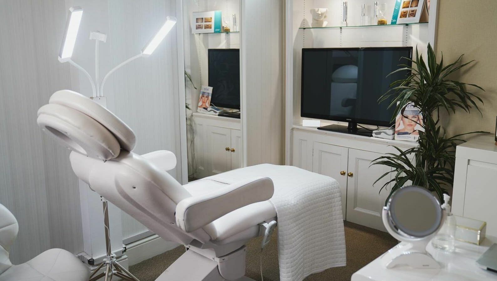Luxurious treatment room at ARC Aesthetics and Laser, featuring a modern white chair in London, England, GB.
