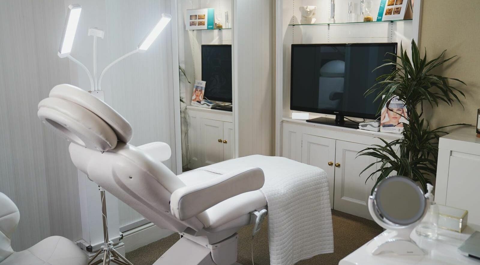 Luxurious treatment room at ARC Aesthetics and Laser, featuring a modern white chair in London, England, GB.