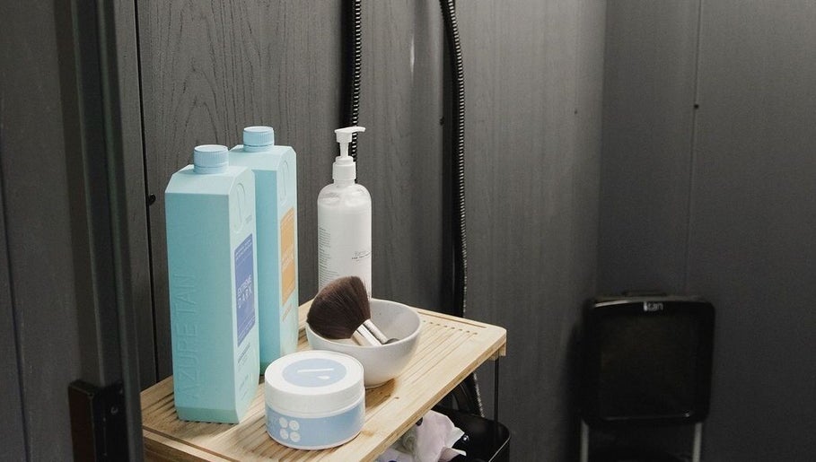 Tanning products at Create Beauty Studio, Hamilton, Waikato Region, NZ on a wooden shelf enhancing the decor.