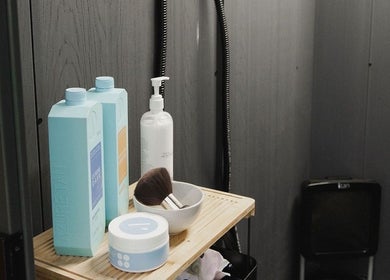 Tanning products at Create Beauty Studio, Hamilton, Waikato Region, NZ on a wooden shelf enhancing the decor.