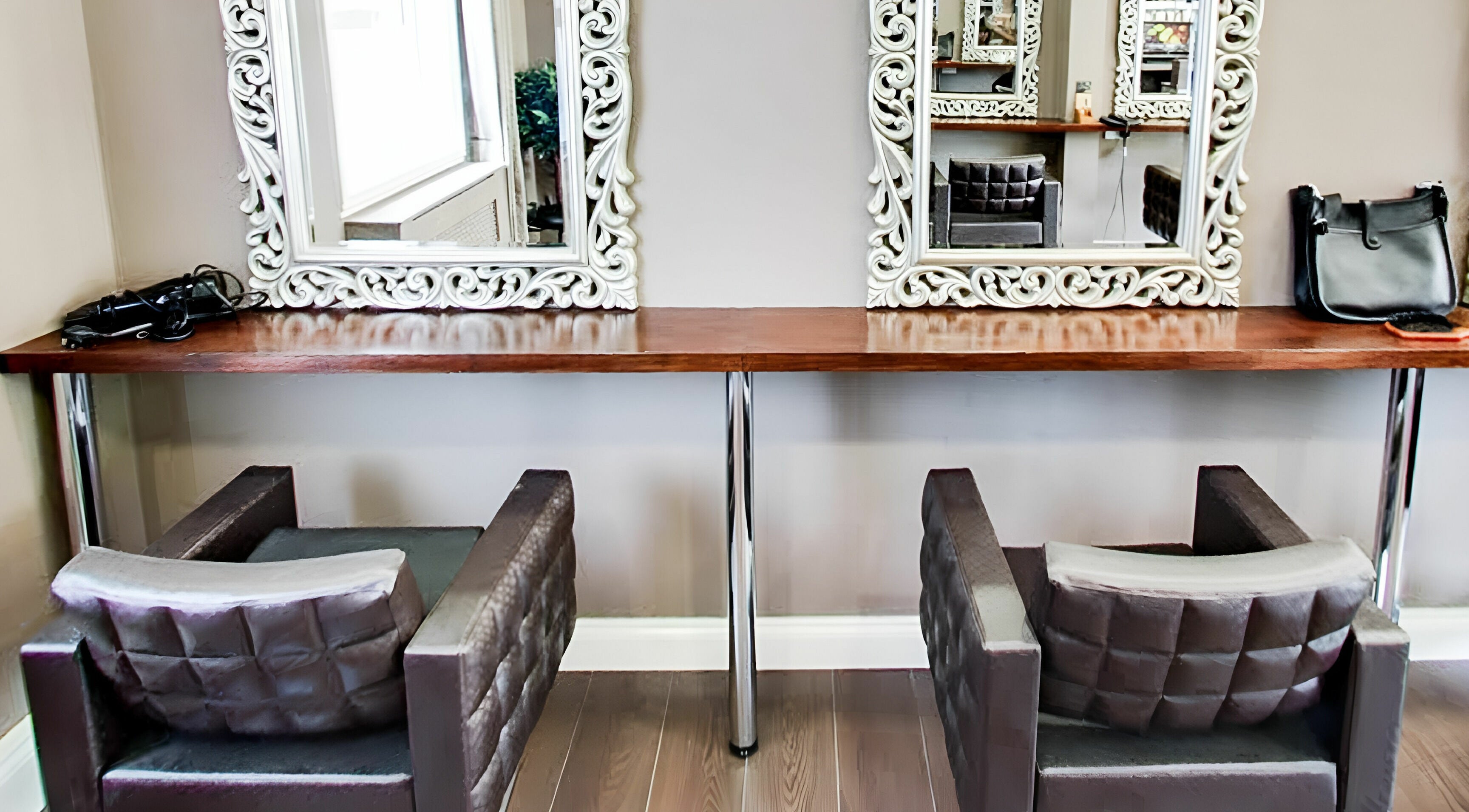 Stylish seating and ornate mirrors at Savas Aveda Salon, London, England, GB for a premium beauty experience.