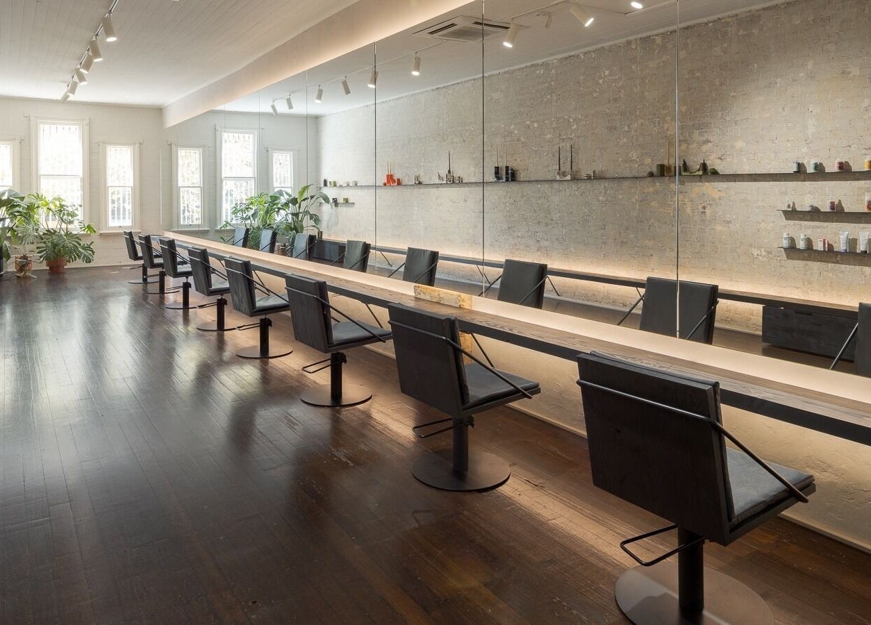 Elegant salon interior at A_STUDIO, Darlinghurst, New South Wales, AU with stylish chairs and mirrors.