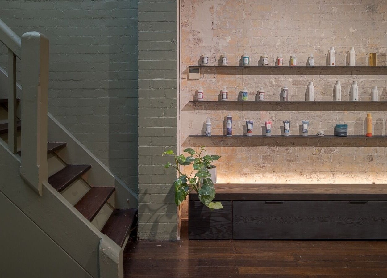 Chic interior of A_STUDIO in Darlinghurst, New South Wales, AU with well-lit product shelves and stairs.