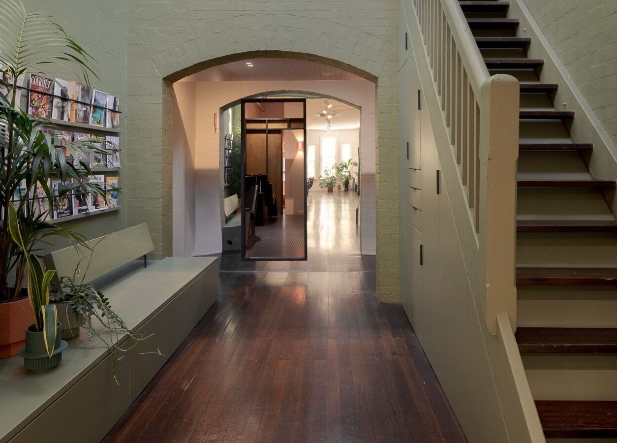 Cozy entrance of A_STUDIO in Darlinghurst, New South Wales, AU with plants and magazines.