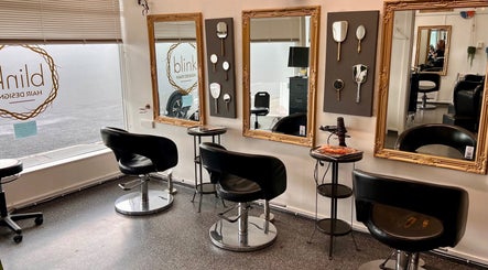 Elegant interior of Blink Hair Design in Christchurch, Canterbury, NZ with stylish chairs and framed mirrors.
