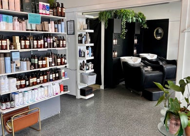 Interior of Blink Hair Design in Christchurch, Canterbury, NZ showing product shelves and hair wash stations.