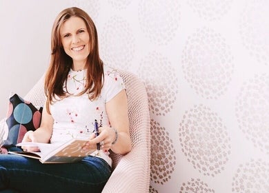 Smiling woman reading in peaceful setting at Maa botanicals wellbeing studio, Franklin, Australian Capital Territory, AU.