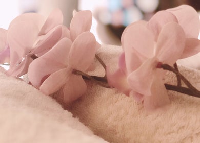 Elegant pink orchids on plush towels at Maa Botanicals Wellbeing Studio, Franklin, Australian Capital Territory, AU.