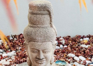 Tranquil stone sculpture surrounded by autumn leaves at Maa Botanicals Wellbeing Studio, Franklin, Australian Capital Territory, AU.
