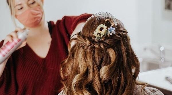 Stylist perfects bridal hairstyle at The Hair Force Marissa Means Beauty, Saint Ann, Missouri, US.