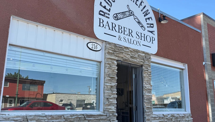 Front exterior of Redcliff Refinery Barbershop & Salon, Redcliff, Alberta, showcasing its modern entrance.