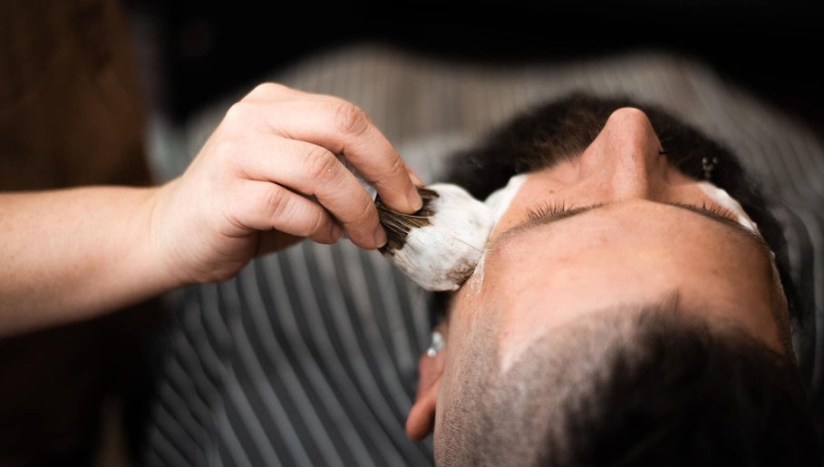 Close-up of a barber applying shaving cream at Redcliff Refinery Barbershop & Salon, Redcliff, Alberta, CA.