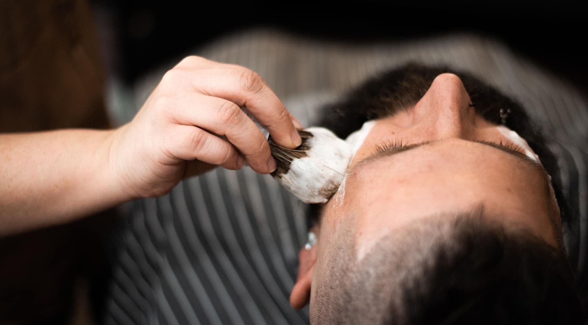 Close-up of a barber applying shaving cream at Redcliff Refinery Barbershop & Salon, Redcliff, Alberta, CA.