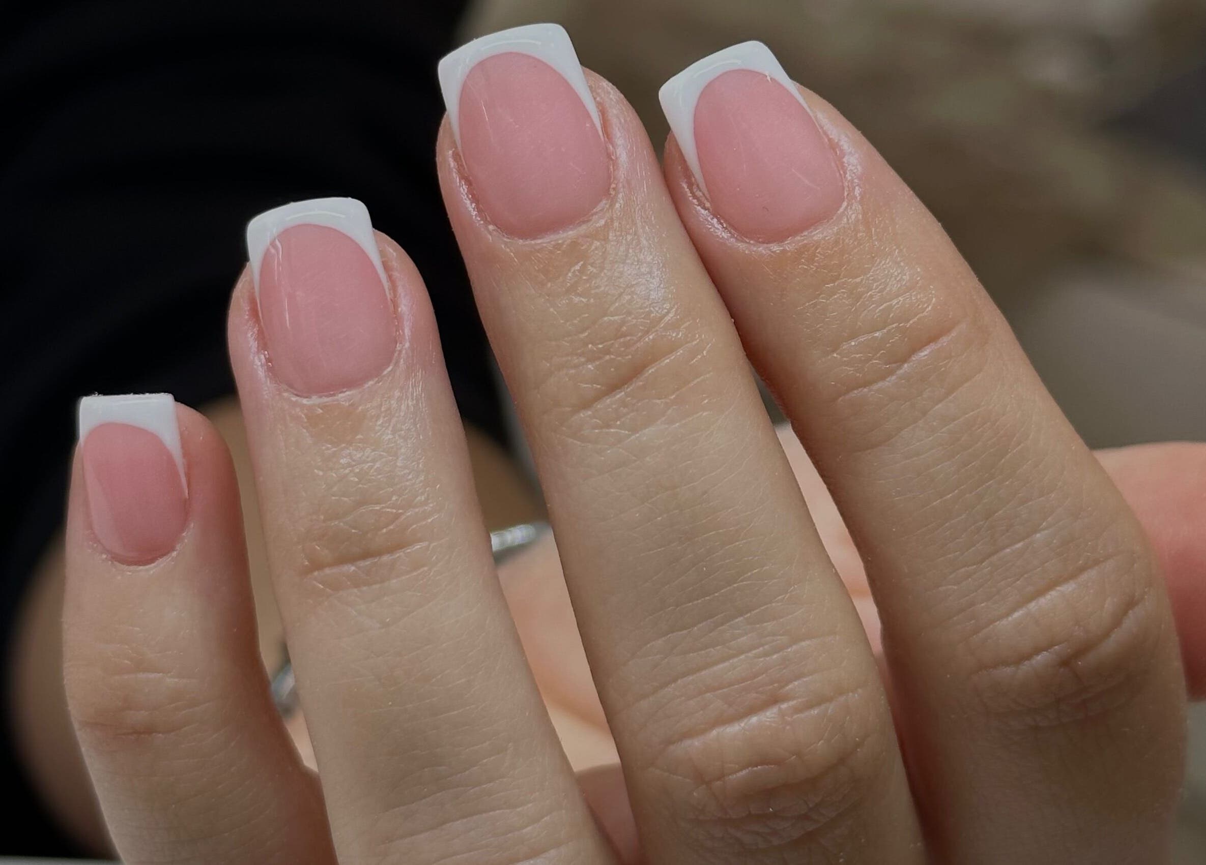 Elegant French manicure at I Hart Beauty, Kirkham, England, GB, showcasing polished pink nails with white tips.