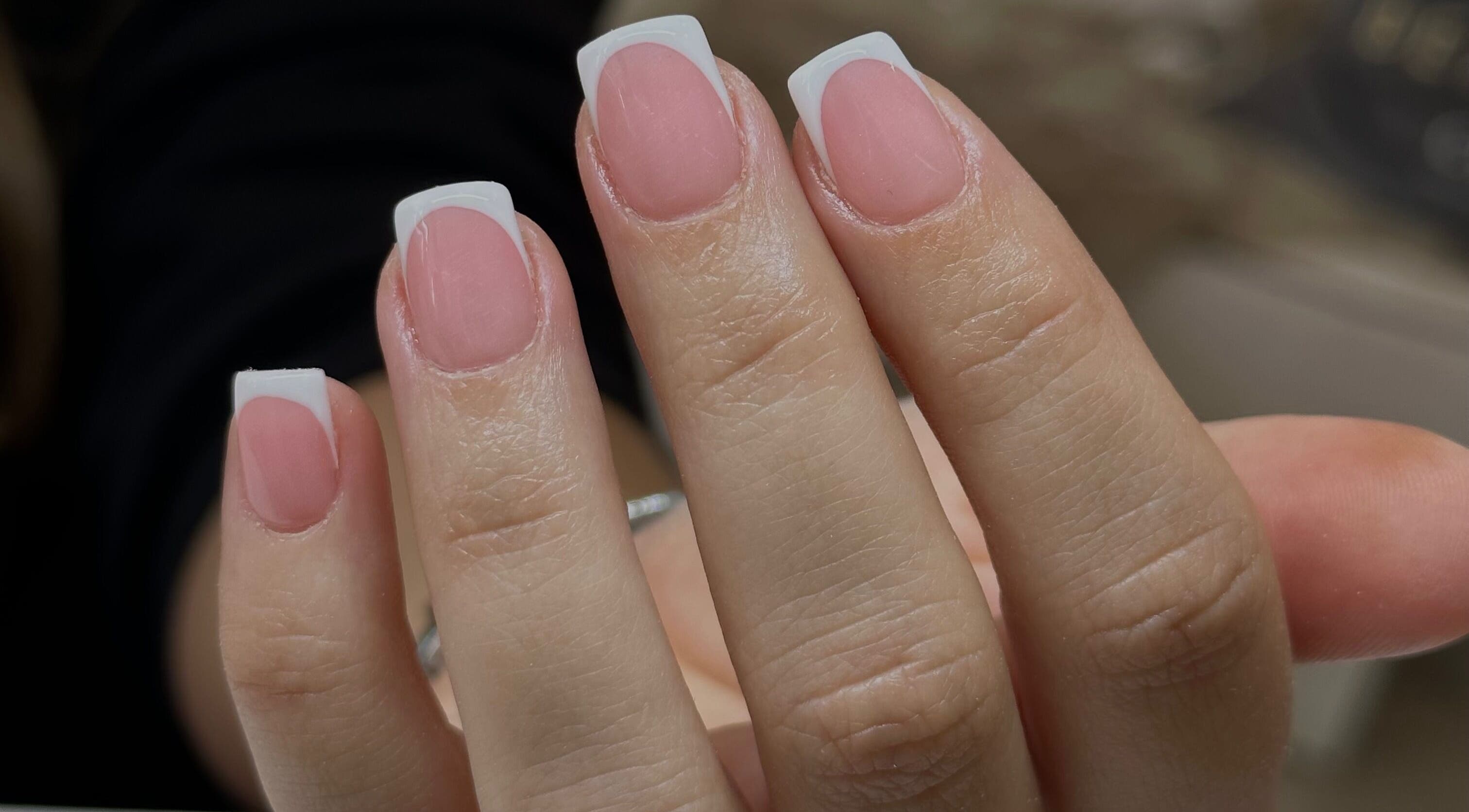 Elegant French manicure at I Hart Beauty, Kirkham, England, GB, showcasing polished pink nails with white tips.