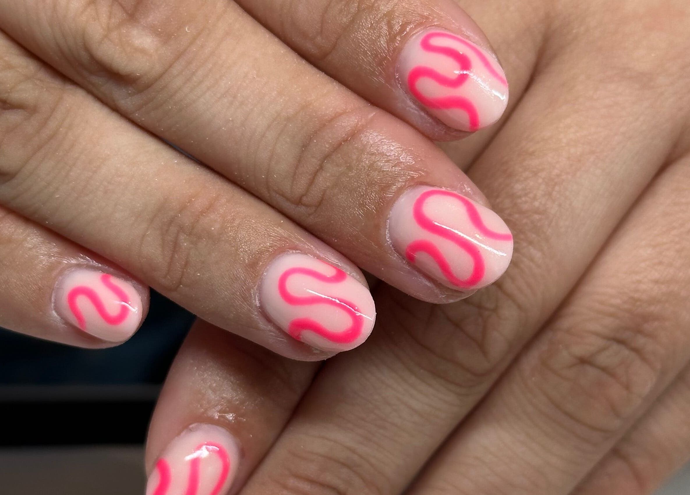 Stylish pink and white nail art from I Hart Beauty in Kirkham, England, GB enhancing hand beauty.