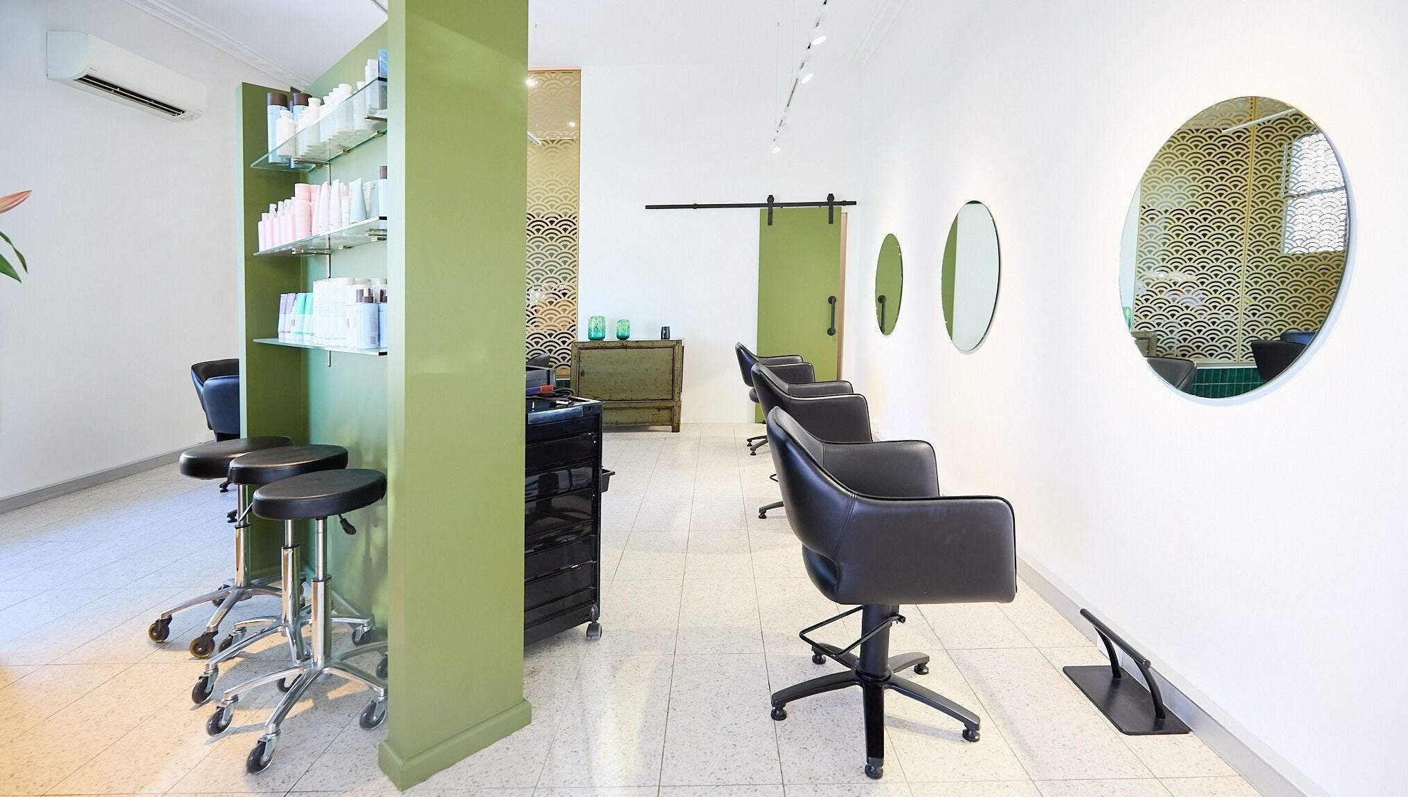 Modern beauty salon interior at Lit & Scott, Stanmore, New South Wales, AU featuring stylish chairs and mirrors.