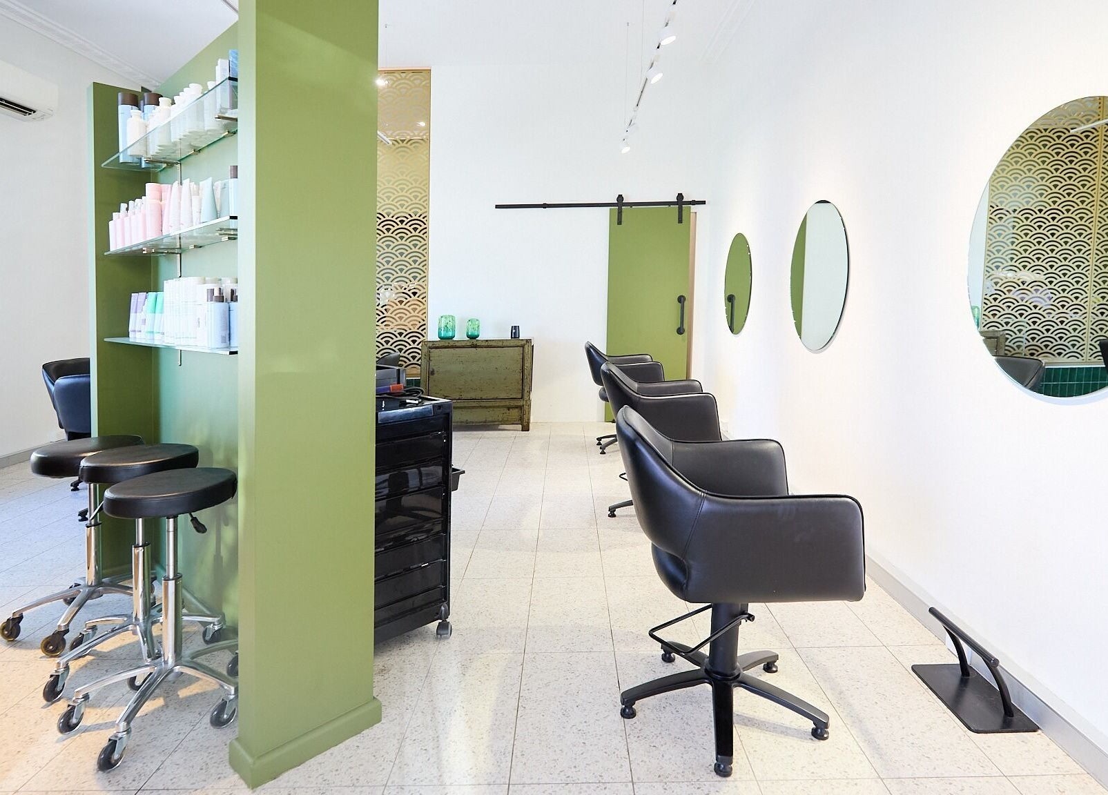 Modern beauty salon interior at Lit & Scott, Stanmore, New South Wales, AU featuring stylish chairs and mirrors.