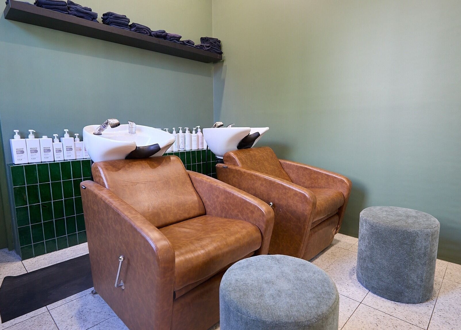 Luxurious hair washing station at Lit & Scott, Stanmore, New South Wales, AU, featuring leather chairs.