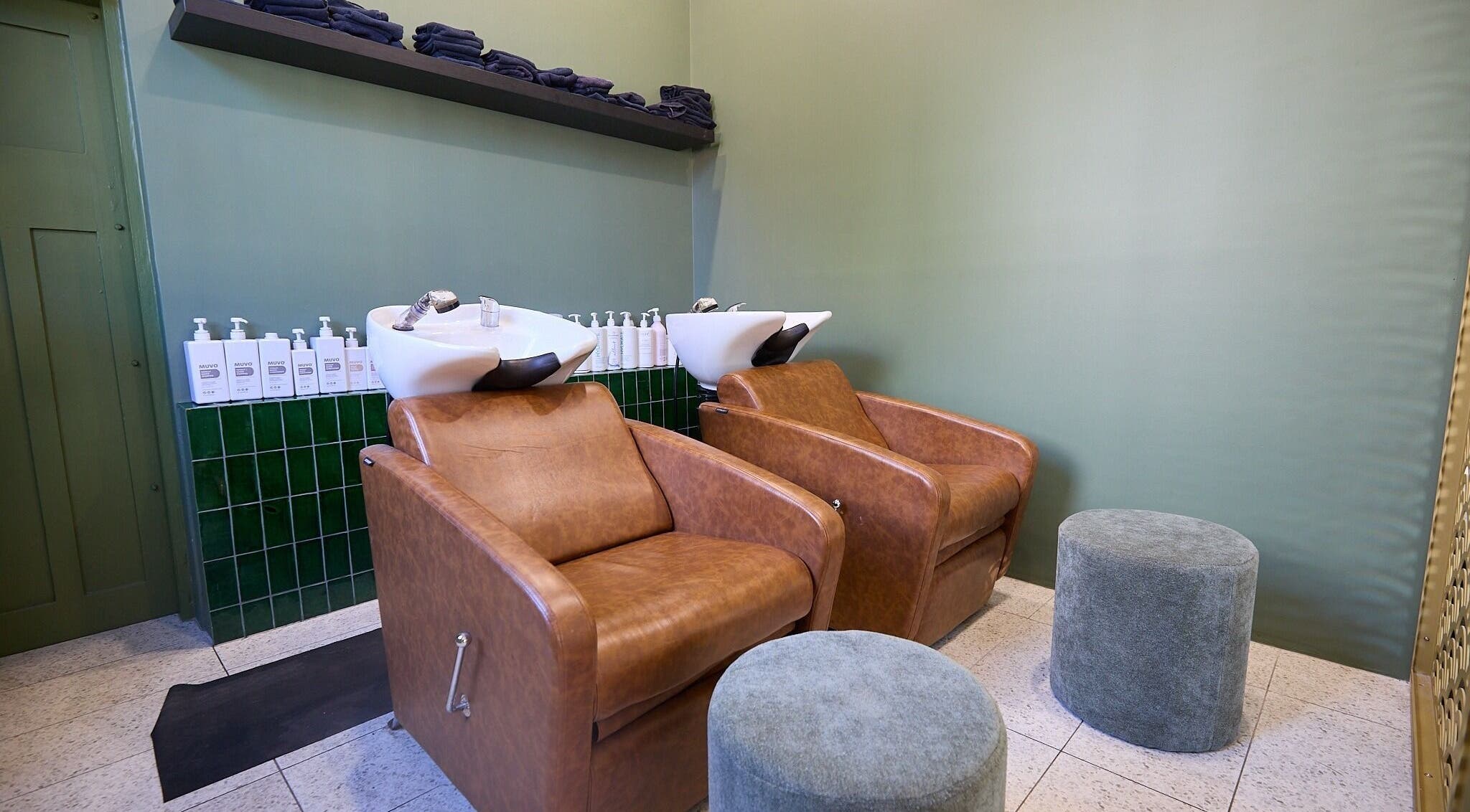 Luxurious hair washing station at Lit & Scott, Stanmore, New South Wales, AU, featuring leather chairs.