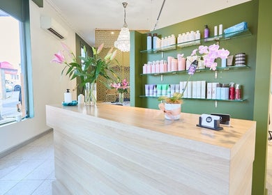Bright, elegant reception area at Lit & Scott, Stanmore, New South Wales, AU, showcasing beauty products and decor.