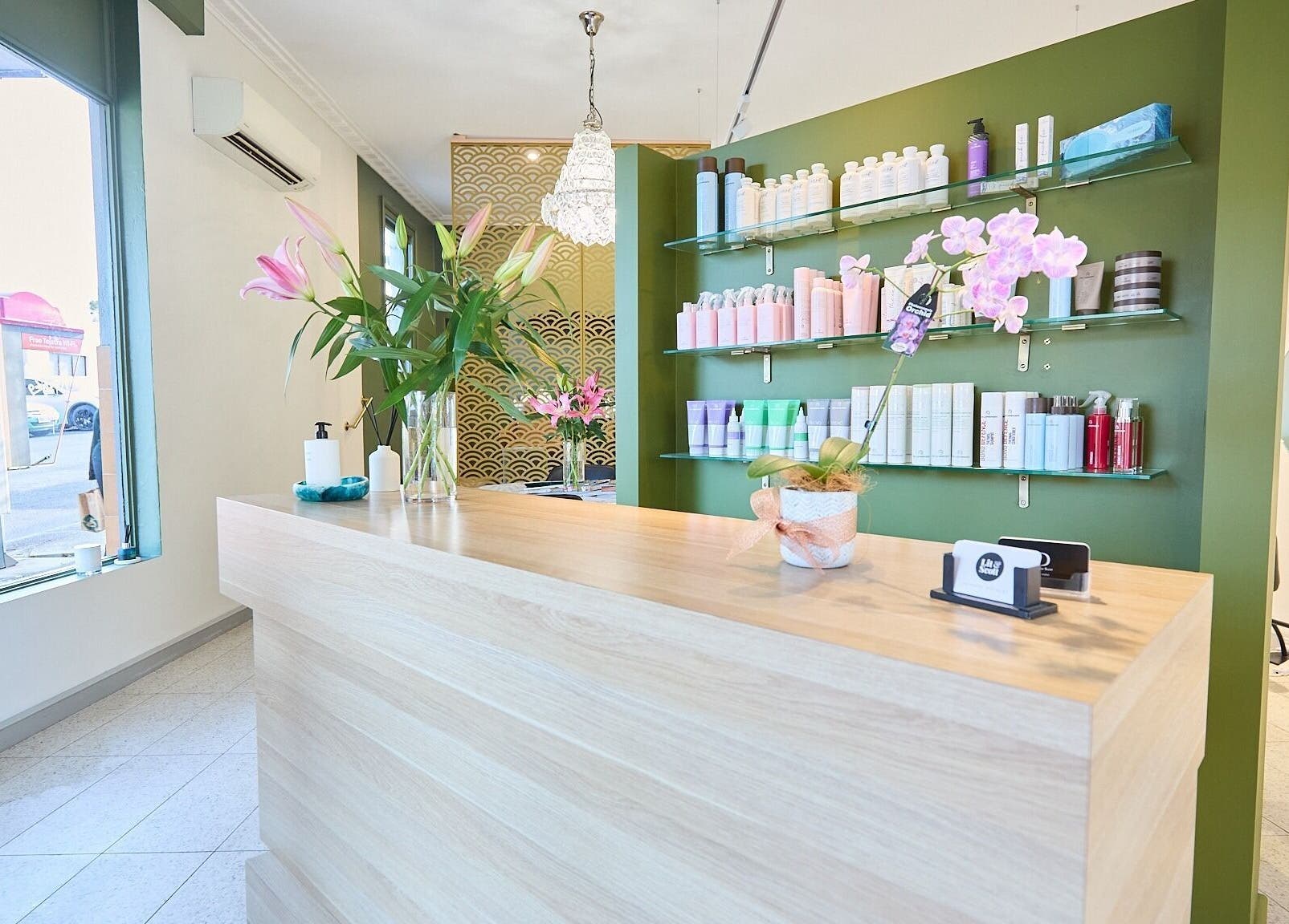 Bright, elegant reception area at Lit & Scott, Stanmore, New South Wales, AU, showcasing beauty products and decor.