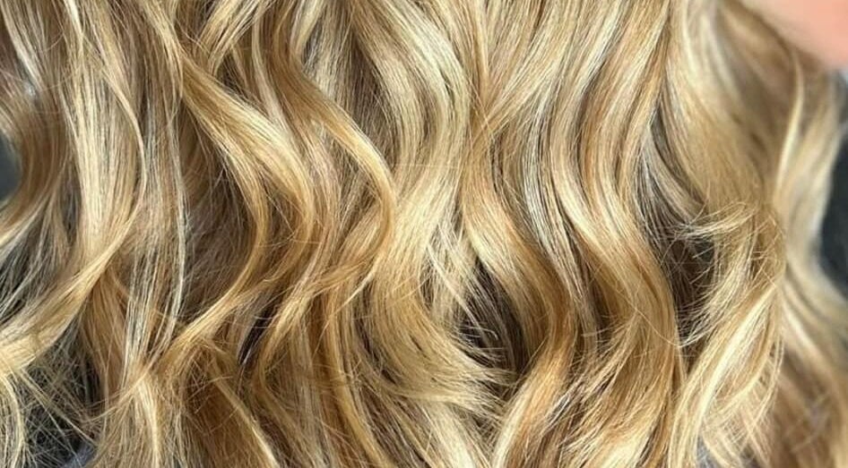 Blonde waves styled at Modern Touch Hair & Beauty in Melbourne, Victoria, AU enhance natural beauty.