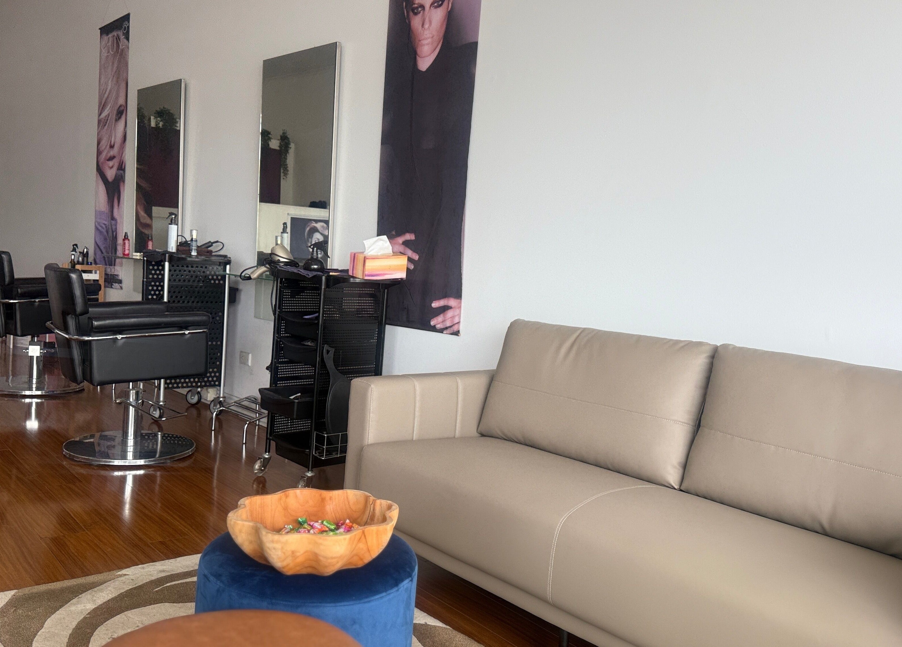 Chic interior at Modern Touch Hair & Beauty in Melbourne, Victoria, AU, featuring sleek salon chairs and comfy seating.