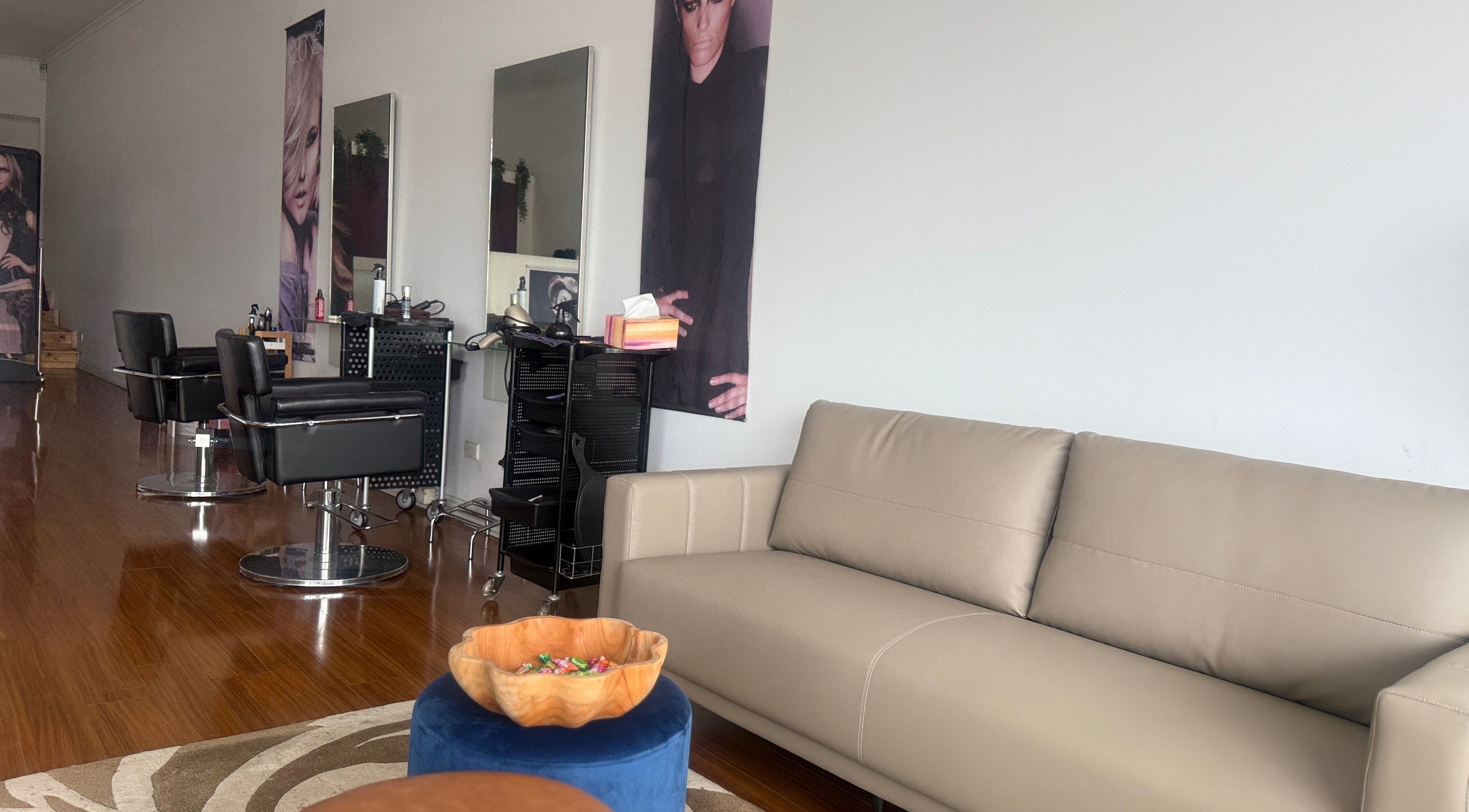 Chic interior at Modern Touch Hair & Beauty in Melbourne, Victoria, AU, featuring sleek salon chairs and comfy seating.