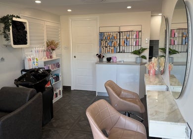 Stylish interior of Unique Hair by Lea salon in Catherine Field, New South Wales, AU showcasing modern chairs and mirrors.